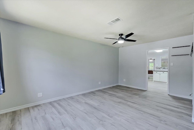 2125 10th St, Port Neches, TX 77651 - spare room with light wood finished floors, a ceiling fan, and baseboards