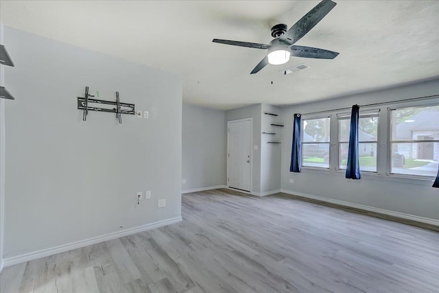 2125 10th St, Port Neches, TX 77651 - spare room with wood finished floors, a ceiling fan, and baseboards