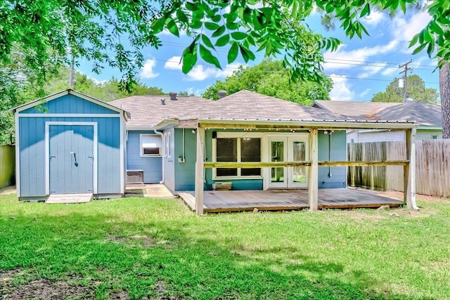 2125 10th St, Port Neches, TX 77651 - back of property with french doors, a deck, a storage unit, central air condition unit, and an outdoor structure