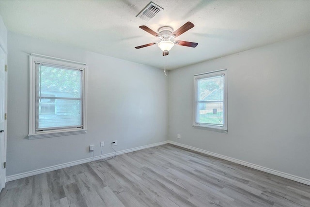 2125 10th St, Port Neches, TX 77651 - unfurnished room with wood finished floors, a ceiling fan, and baseboards