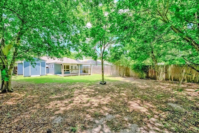 2125 10th St, Port Neches, TX 77651 - fenced backyard featuring a storage shed and an outdoor structure