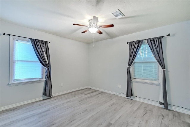 2125 10th St, Port Neches, TX 77651 - unfurnished room with ceiling fan, wood finished floors, and baseboards