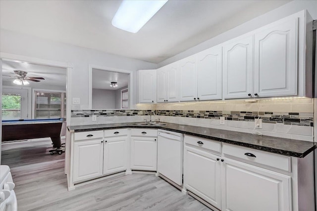 2125 10th St, Port Neches, TX 77651 - kitchen featuring white dishwasher, a sink, decorative backsplash, and white cabinets