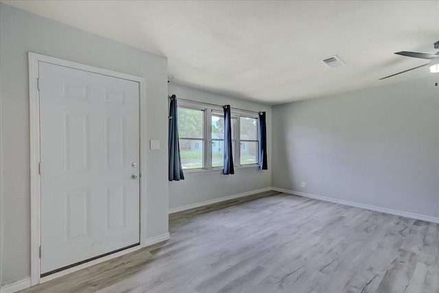 2125 10th St, Port Neches, TX 77651 - spare room featuring a ceiling fan, light wood-style floors, and baseboards