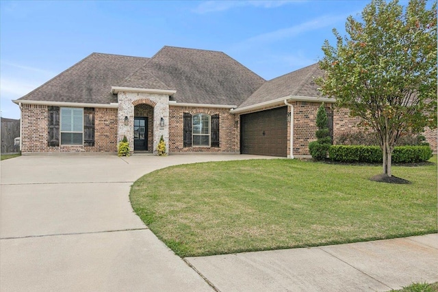 view of front of home featuring a garage and a front lawn