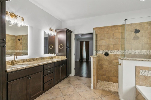 bathroom featuring tiled shower, vanity, and tile patterned floors