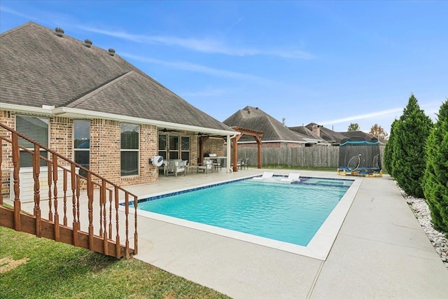 view of pool featuring a trampoline and a patio