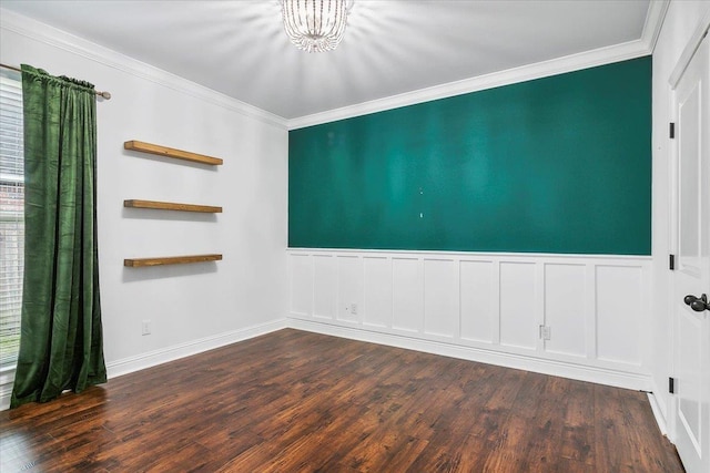 empty room featuring ornamental molding, dark wood-type flooring, and an inviting chandelier