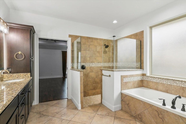 bathroom featuring tile patterned floors, vanity, and plus walk in shower