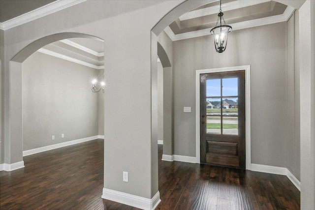 entryway with a notable chandelier, crown molding, and dark wood-type flooring