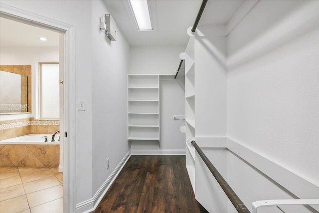 walk in closet featuring dark wood-type flooring