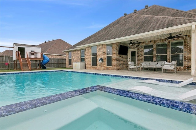 view of swimming pool featuring an in ground hot tub, an outdoor living space, a playground, and a patio area