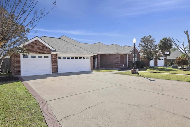 single story home featuring brick siding, roof with shingles, an attached garage, driveway, and a front lawn