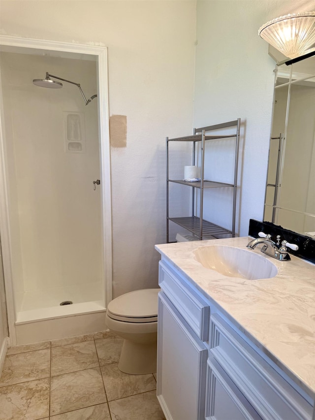 full bathroom with a shower stall, vanity, and toilet