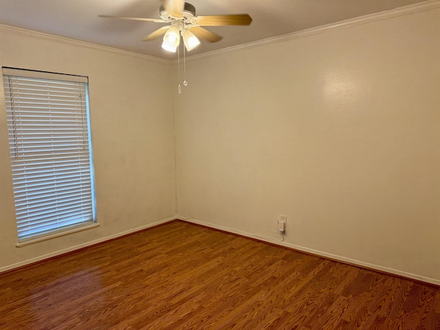 spare room featuring baseboards, crown molding, a ceiling fan, and wood finished floors