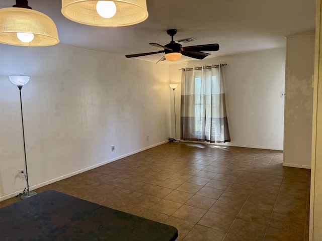 spare room with tile patterned floors, baseboards, and ceiling fan