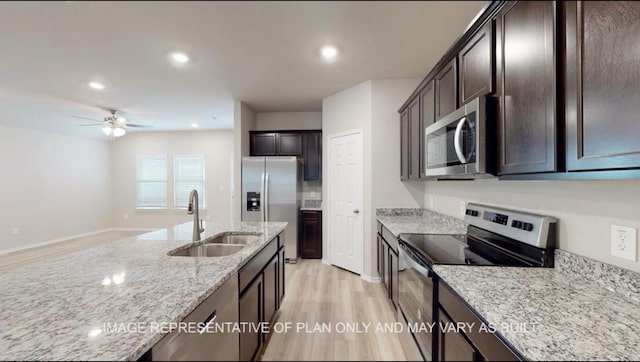1690 Haidlyns Way, Sour Lake, TX 77659 - kitchen featuring appliances with stainless steel finishes, a sink, light wood finished floors, a ceiling fan, and dark brown cabinetry