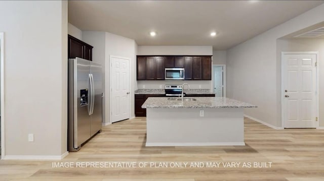 1690 Haidlyns Way, Sour Lake, TX 77659 - kitchen with appliances with stainless steel finishes, a sink, light wood-type flooring, dark brown cabinets, and recessed lighting