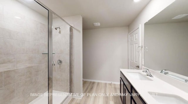 1690 Haidlyns Way, Sour Lake, TX 77659 - bathroom featuring a shower stall, double vanity, wood finished floors, and baseboards