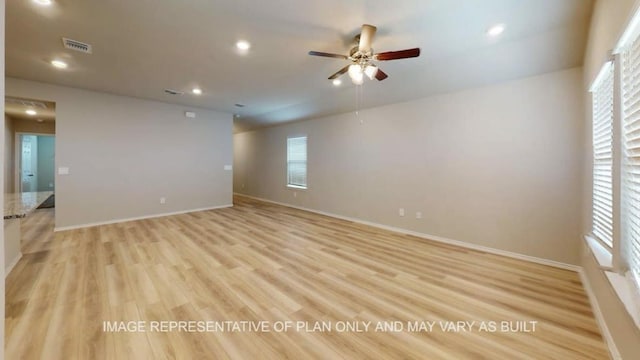 1690 Haidlyns Way, Sour Lake, TX 77659 - empty room with a ceiling fan, plenty of natural light, light wood finished floors, recessed lighting, and baseboards