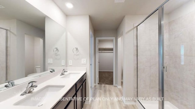 1690 Haidlyns Way, Sour Lake, TX 77659 - bathroom with toilet, wood finished floors, double vanity, and a stall shower