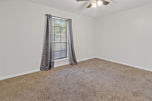 spare room featuring carpet, a textured ceiling, and ceiling fan