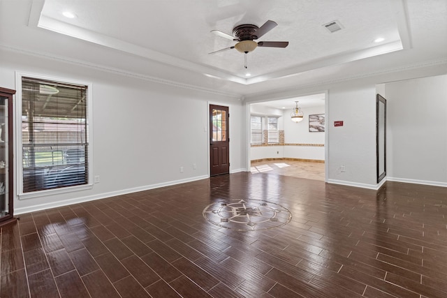 interior space featuring ceiling fan and a tray ceiling