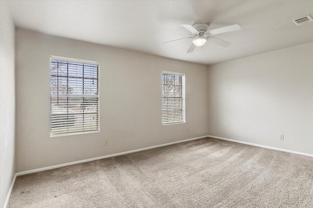 spare room with carpet floors and ceiling fan