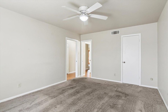 unfurnished room with ceiling fan and carpet flooring