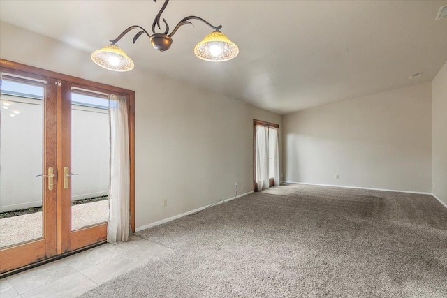 unfurnished room featuring light colored carpet and french doors