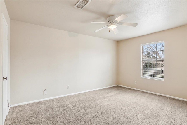 carpeted empty room featuring a textured ceiling and ceiling fan