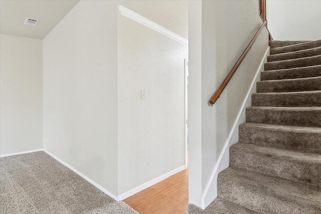 stairs featuring hardwood / wood-style floors