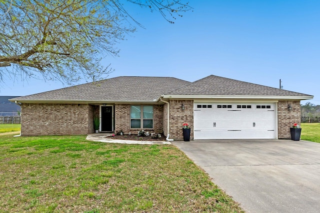 ranch-style home with a garage and a front lawn