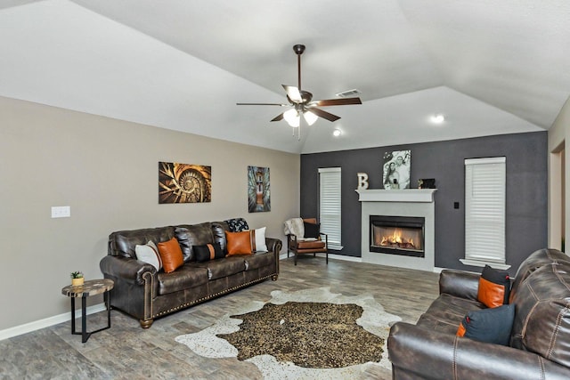 living room featuring vaulted ceiling, hardwood / wood-style flooring, and ceiling fan