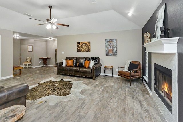 living room featuring lofted ceiling, ceiling fan, and hardwood / wood-style floors