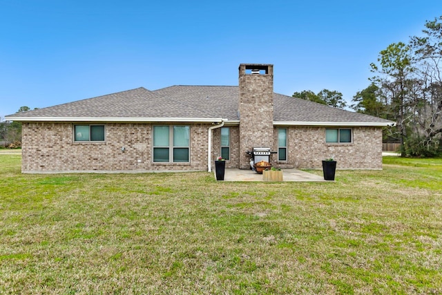 back of property featuring a yard and a patio