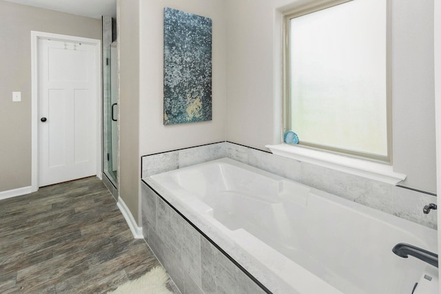 bathroom with plus walk in shower and wood-type flooring