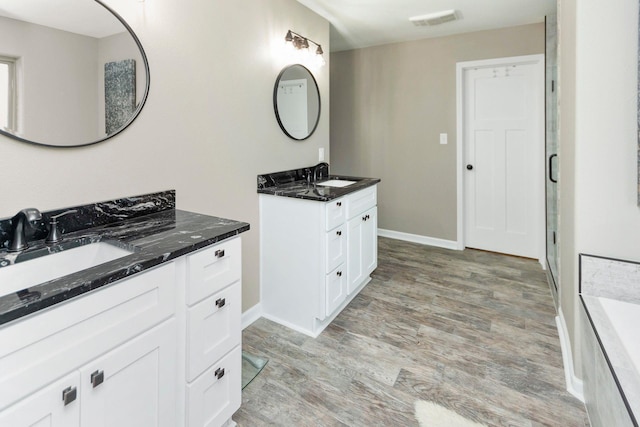 bathroom with vanity and hardwood / wood-style floors