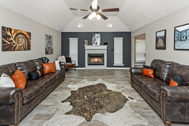 living room featuring hardwood / wood-style floors, ceiling fan, and vaulted ceiling