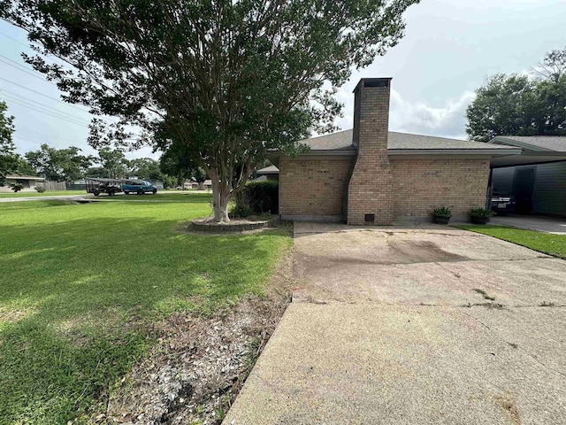 view of side of home with a yard