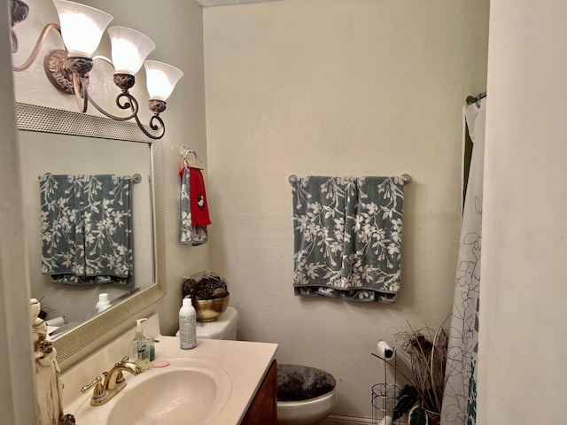 bathroom featuring vanity and toilet