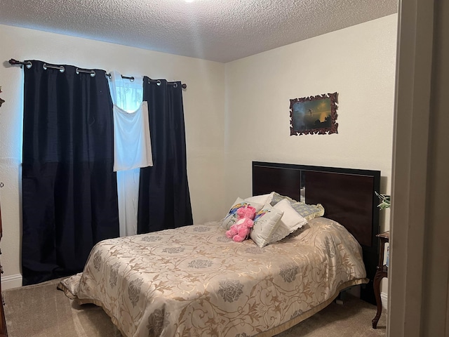 carpeted bedroom featuring a textured ceiling