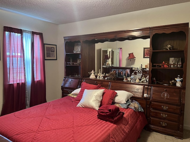 carpeted bedroom with a textured ceiling