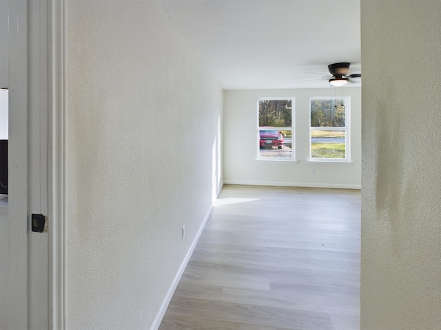 5260 Landry Ln, Beaumont, TX 77708 - corridor featuring a textured wall, baseboards, and wood finished floors