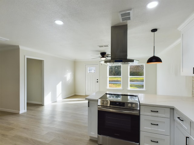 5260 Landry Ln, Beaumont, TX 77708 - kitchen featuring white cabinets, island exhaust hood, visible vents, stainless steel range with electric stovetop, and ornamental molding
