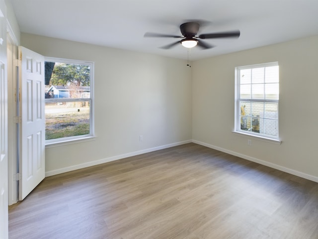 5260 Landry Ln, Beaumont, TX 77708 - spare room featuring light wood-type flooring, baseboards, ceiling fan, and a healthy amount of sunlight