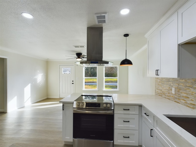 5260 Landry Ln, Beaumont, TX 77708 - kitchen featuring a wealth of natural light, island range hood, stainless steel electric range oven, and white cabinetry
