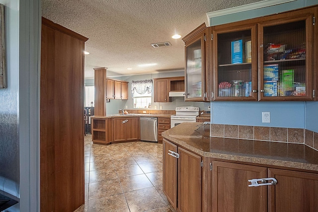 kitchen with a textured ceiling, white range oven, sink, light tile patterned floors, and dishwasher