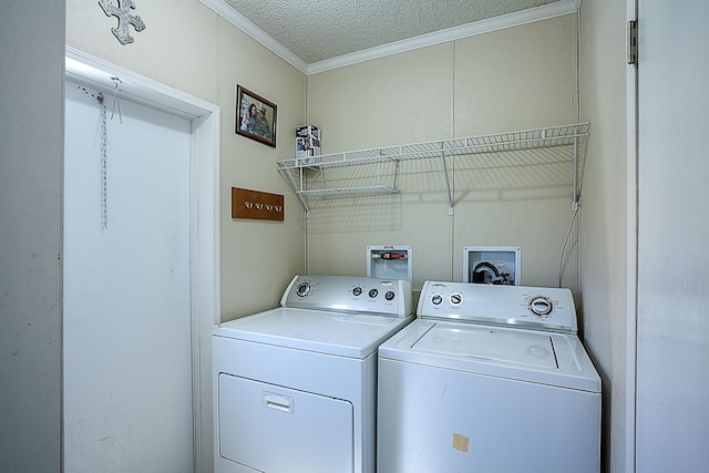 laundry room featuring ornamental molding, a textured ceiling, and independent washer and dryer