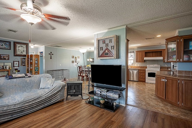 living room featuring wood-type flooring, a textured ceiling, and ceiling fan